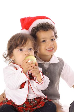 toddler in santa hat with sisterの写真素材