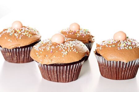 yummy chocolate cupcakes isolated on whiteの写真素材