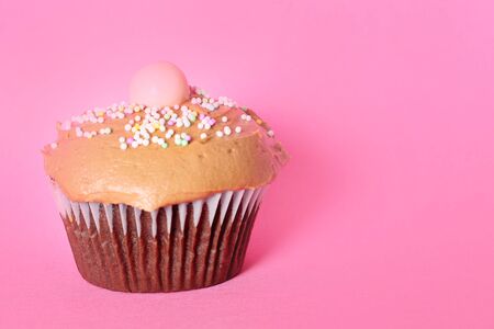 chocolate cupcake on pink backgroundの写真素材