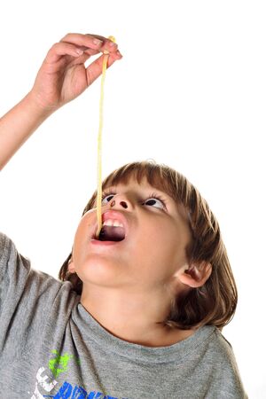 child eating pasta noodleの写真素材