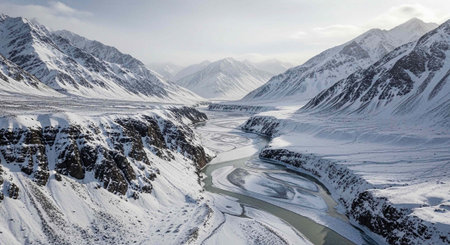Panoramic view of snow-covered mountains and a river.の写真素材