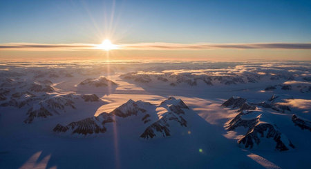 Aerial view of snow covered mountains at sunset. Beautiful winter landscape.