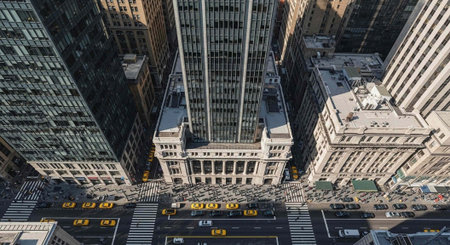 Aerial view of a bustling city street with tall buildings and busy traffic
