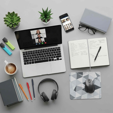 Top view of modern workplace with laptop, smartphone, notebook, stationery and headphones on grey background