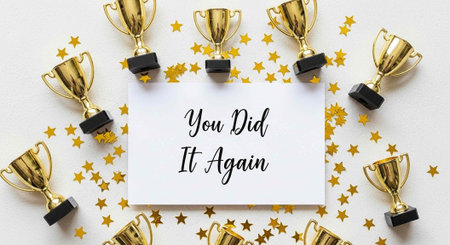 A congratulatory message surrounded by gold trophies and stars on a white background