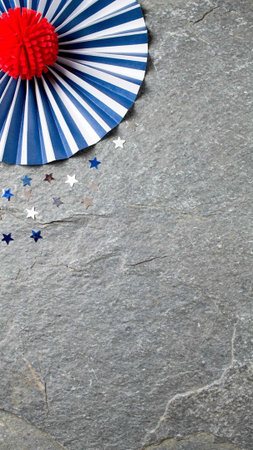 Japanese paper fan on stone background. Top view with copy space.