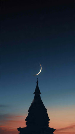 Silhouette of pagoda and crescent moon at sunset.