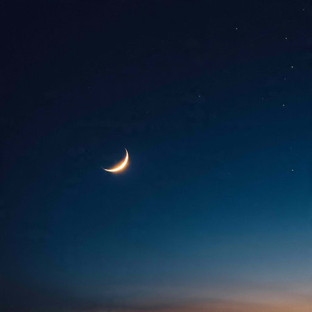 Crescent moon in the night sky with stars on the background.