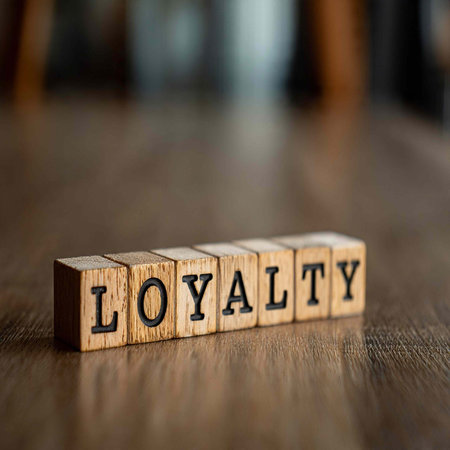Wooden cubes with the word LOYALTY on the table