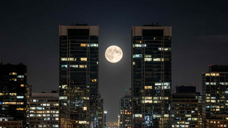 Night cityscape with a full moon on the background of tall buildings