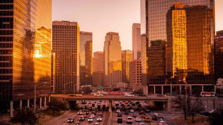 Houston, Texas, USA downtown skyline at dusk with traffic on the road.