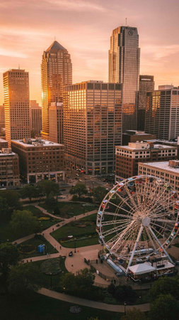 Philadelphia, Pennsylvania, USA downtown skyline at sunset with a ferris wheel.
