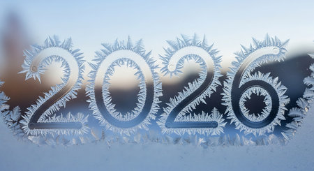 Intricate frost patterns on window glass display year 2026, winter background, cold weather, ice crystals, frozen artwork.の素材