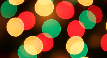 Blurred vibrant red yellow green lights; festive soft focus circular light pattern; abstract bokeh holiday celebration backgroundの素材