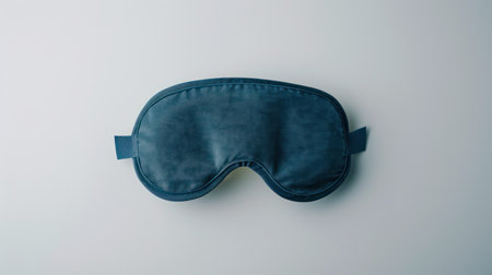 Blue sleeping mask isolated on white background. Top view. Flat lay.の素材