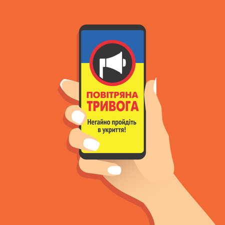 Female hand hold smartphone with air raid alert message in Ukrainian language. Woman showing cell phone with air-raid warning. Government of Ukraine informs about the danger. Vector EPS8 illustration.のイラスト素材