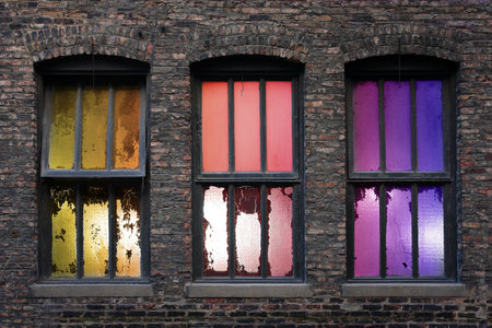 3 old weathered windows with backlight during sunsetの写真素材
