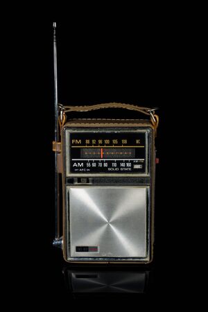 Vintage retro portable radio isolated on black backgroundの写真素材