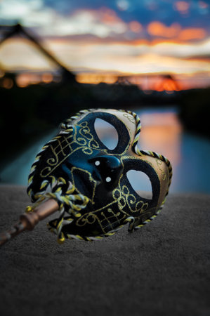 Venetian Mask by the River Bridge with Sunsetの写真素材