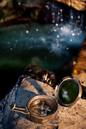 Lost - Vintage Geography Compass on Rock by Waterfallの写真素材