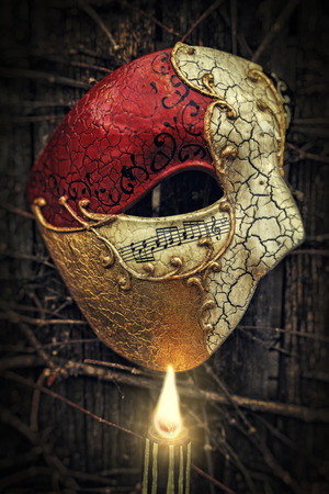 Vintage Venetian Musical Notes Mask with Candleの写真素材
