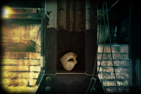 Lurking in the Shadows - Phantom of the Opera Mask in Dark Tunnelの写真素材