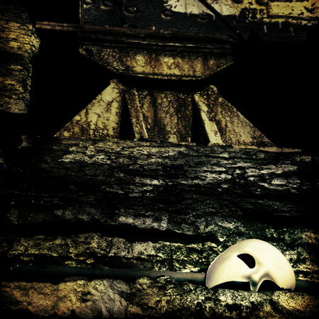 Lurking in the Shadows - Phantom of the Opera Mask on Vintage Bridgeの写真素材