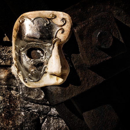 Lurking in the Shadows - Phantom of the Opera Mask on Dark Wallの写真素材