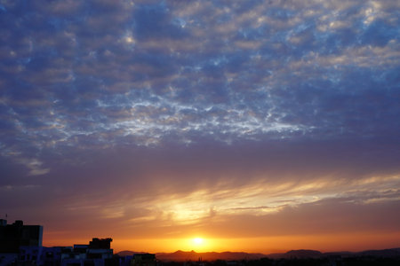 Sunrise on the blue and cloudy sky.の写真素材