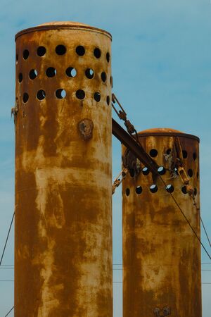 Abandoned old and rusty factory chimneyの写真素材