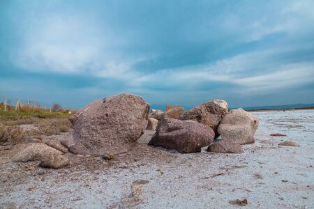 A seaside scene in Turkey with rocks in both the foreground and background under a blue sky.の写真素材
