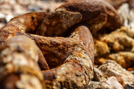 Old metal rusty anchor chain on sunsetの写真素材