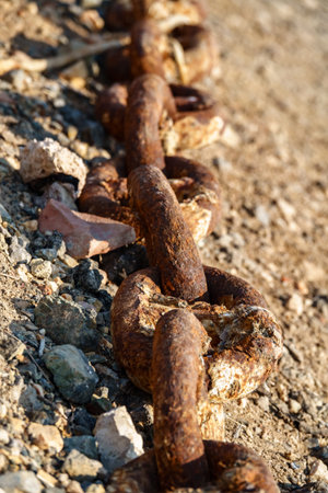 Old metal rusty anchor chain on sunset