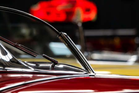 Red classic car windshield in a gallery museum.の写真素材