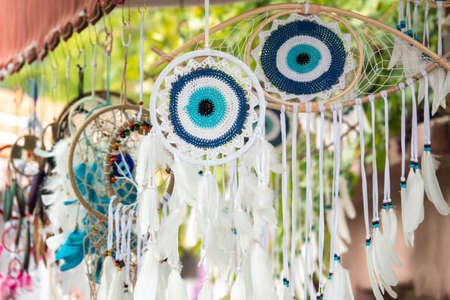 Evil eye beads and dream catchers hanging from the ceiling outside the storeの写真素材