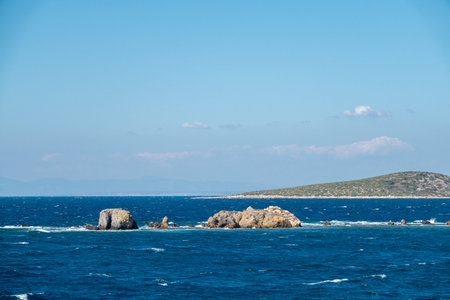 mountain scenery in the background and small islets in the middle of the sea