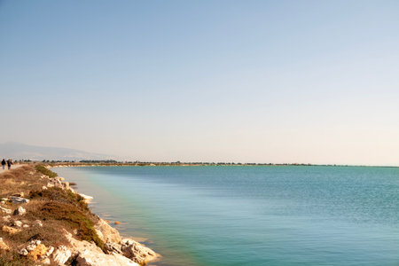 Scenic coastal scene with rocky shoreline and turquoise waters.の写真素材