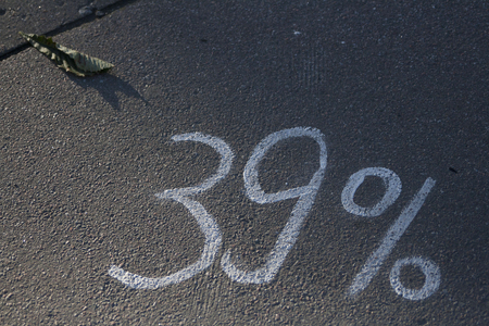 White chalk numbers and the leaf on the pavementの写真素材