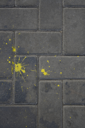 Abstract yellow splat on the grey pavementの写真素材