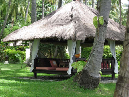 daybed in tropical gardenの写真素材