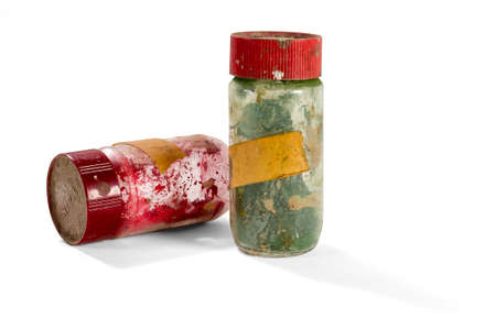 Two old and dirty glass cans containing dust colors - with clipping pathの写真素材