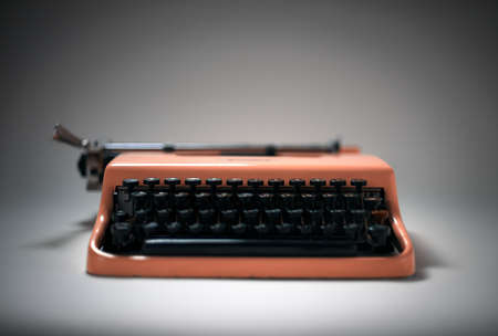 Vintage pink typewriter in evocative spotlight and focusの写真素材