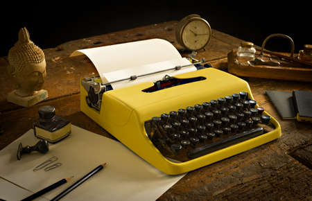 Vintage typewriter above an old wooden deskの写真素材