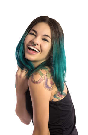 Beautiful laughing girl on white background. Tattooed, pierced, and turquoise haired.の写真素材