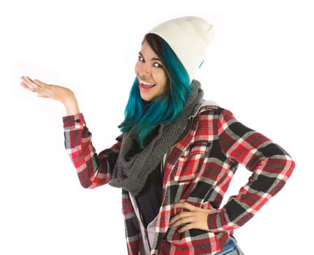 Beautiful smiling girl showing something on white background. Pierced, turquoise haired and dressing up a plaid shirt.の写真素材