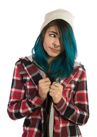 Beautiful hipster girl looking forward on white background. Pierced, turquoise haired and dressing up in plaid shirt.の写真素材