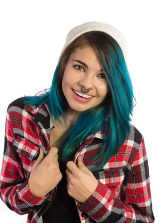 Beautiful hipster girl smiling with fun on white background. Pierced, turquoise haired and dressing up a plaid shirt.の写真素材