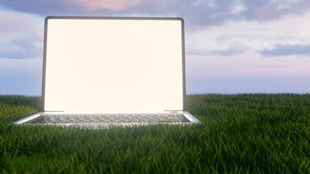 A laptop is standing in a meadow - working in the green concept -- 3D renderingの写真素材