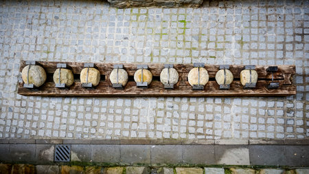 Old cannon balls displayed on a street in Pamplonaの写真素材