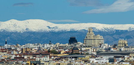 Panoramic view of the capital city with the partially snow-covered mountains in the background.の写真素材